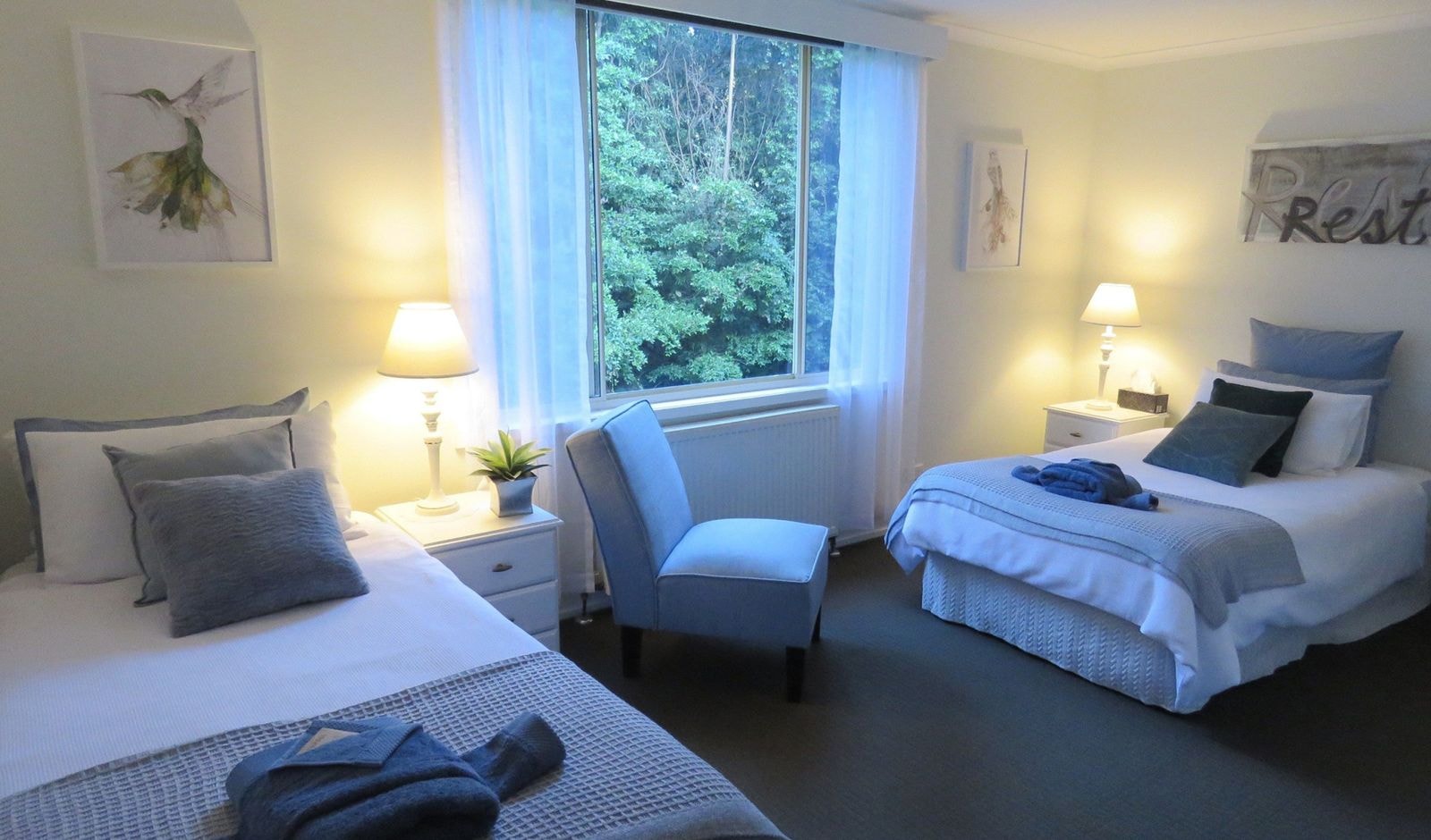 A twin-share guest room made up with white linen